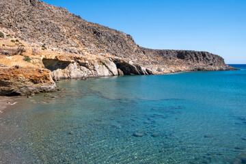 Fototapeta na wymiar View of rocky coastline of Kato Zakros, transparent seabed with pebbles. Lasithi Province, Crete Greece 