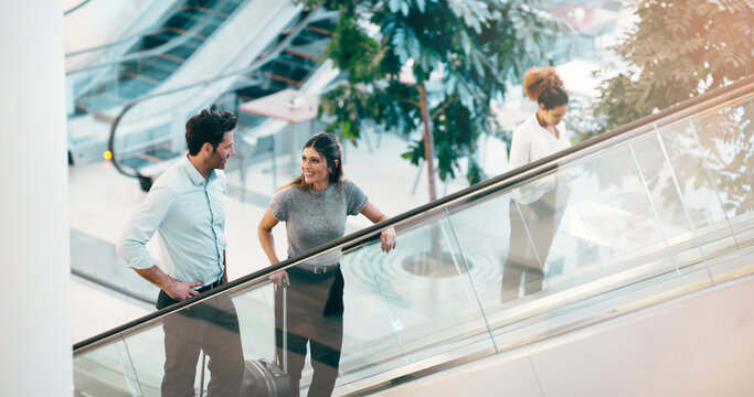 Escalator, business people and staff talking, discussion and happiness with ideas, planning or chatting. Man, woman or coworkers in a modern office, conversation or communication on a moving stairway