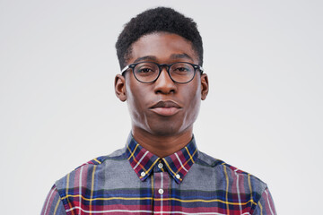 Face portrait, serious geek and black man in studio isolated on white background. African, nerd and...