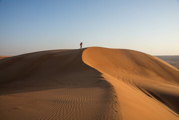 Walking in desert sand dunes, Wahiba Sands, Ash Sharqiyah, Oman