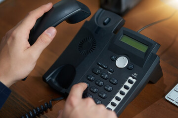 Hand dial, voip telephone and office for communication, contact us and consulting agent. Telemarketing person, phone call or button on table for customer service, help or tech support on network
