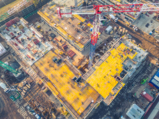 Busy Construction Site and Construction Equipment. new residential area. crane and building under construction . aerial view
