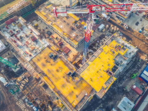 Busy Construction Site and Construction Equipment. new residential area. crane and building under construction . aerial view © netsay