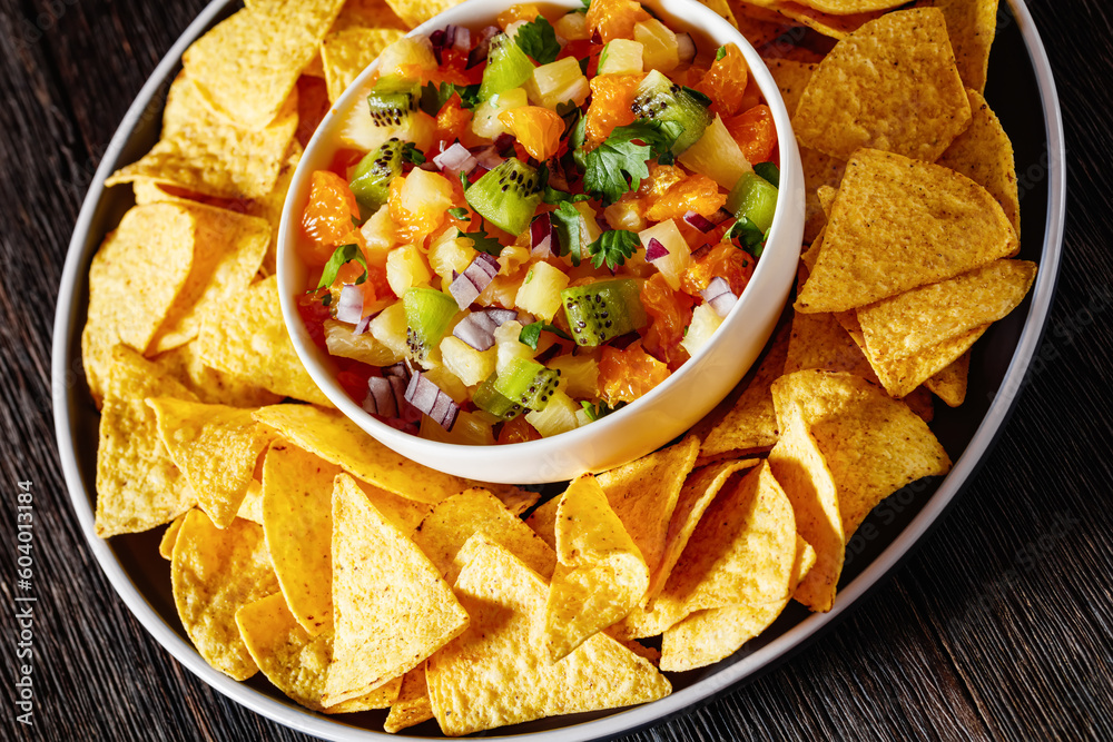 Sticker summer fruit salsa with tortilla chips on plate