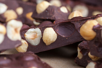 Pieces of homemade milk chocolate with lots of hazelnuts