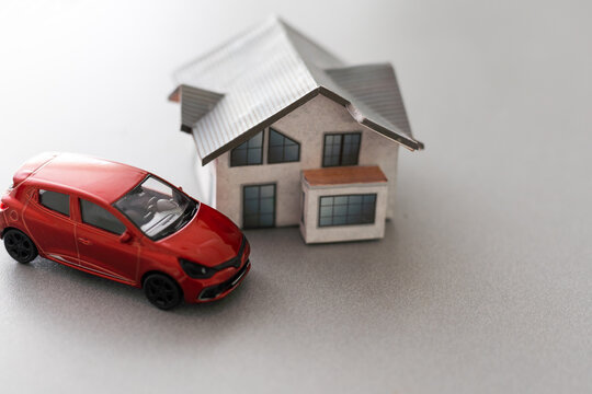 Home and car artificial on the concrete.