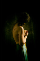 woman in green skirt reading a book in romantic attitude IV