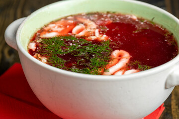 a bowl of traditional red beet borscht with sour cream and dill