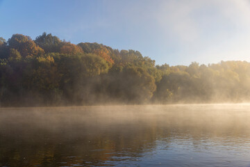 Fog-covered river in the autumn season