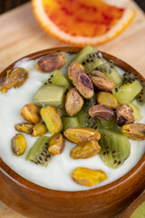 fresh green yogurt with pieces of kiwi and pistachios