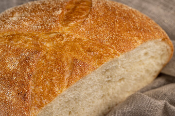 A cut loaf of round-shaped wheat bread
