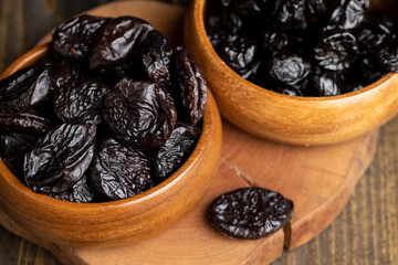 Black pile of prunes from a large number of ripe plums