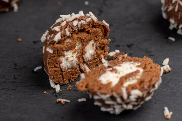 Chocolate candies in the form of balls with milk coconut