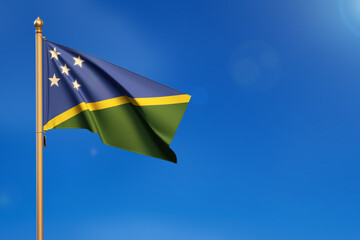 Solomon Islands. Flag blown by the wind with blue sky in the background.