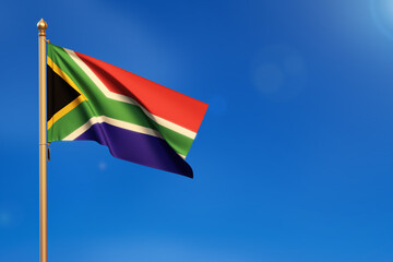 South Africa. Flag blown by the wind with blue sky in the background.