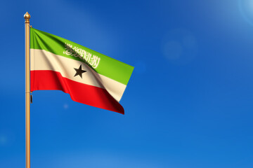 Somaliland. Flag blown by the wind with blue sky in the background.