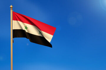 Syria. Flag blown by the wind with blue sky in the background.