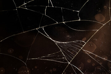 glass broken into a large number of pieces and cracks
