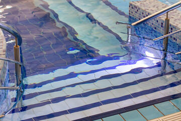 Handrails and steps for safe descent into the pool.