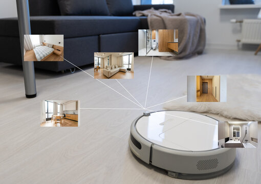 people, housework and technology concept. robot vacuum cleaner.