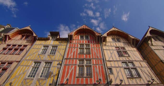 Time lapse view of a beautiful street with old traditional French houses in the center of Troyes with clouds in the background. Establishing shot. Legacy of French history. Colorful houses in France