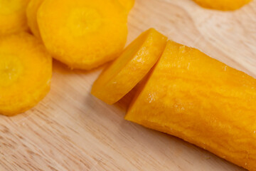 Sliced bright yellow carrots on the table