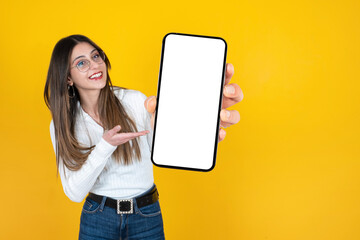 Holding smartphone, caucasian young girl holding smartphone. Portrait of beautiful woman presenting close up image of empty blank screen mobile phone mockup.  Mobile application advertisement concept. - Powered by Adobe