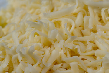 Hard cheese with holes grated into thin small slices