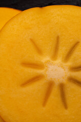 Half-cut ripe and sweet persimmon, close up