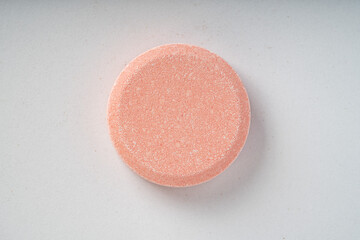 Close up of of chewable antacid acid reducer tablets with fruit flavor on white paper background