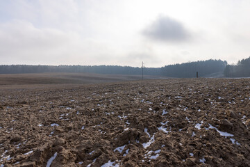 the soil prepared for sowing in the field at the end of winter