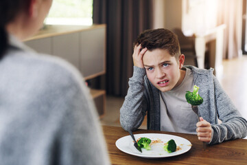 Disgust, food and child with vegetables in home for nutrition, health and cooking. Lunch, angry and...