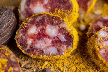Sliced pork salami with spices and lots of turmeric