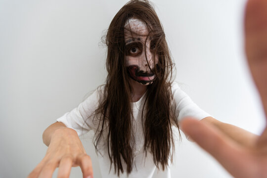 scary girl in white dress from horror film in room
