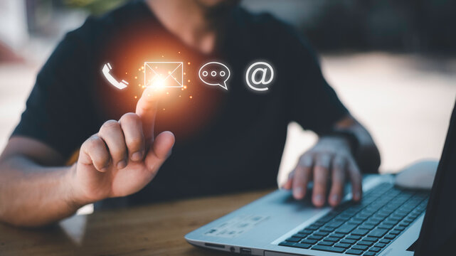 Businessman using Smart Phone with the email, call phone, address, Chat message icons.Customer support hotline Contact us people connection.