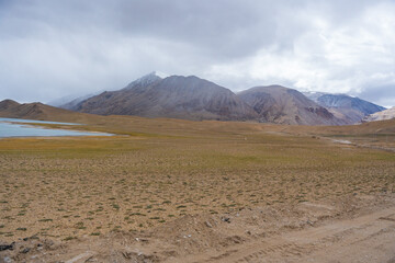 Landscape of Desert mountains against clouds sky at the way from Pangong Lake to Tso Moriri, Leh, Ladakh, Jammu and Kashmir, India