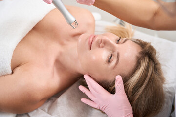 Obraz na płótnie Canvas Top view of lady on laser skin resurfacing procedure