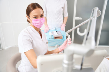 Cute doctor at workplace in aesthetic medicine clinic