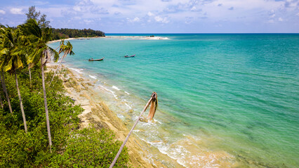 Aerial view of palm trees and a beach in Khao Lak, Phang Nga, Thailand