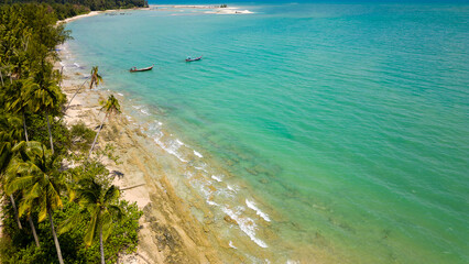 Aerial view of palm trees and a beach in Khao Lak, Phang Nga, Thailand