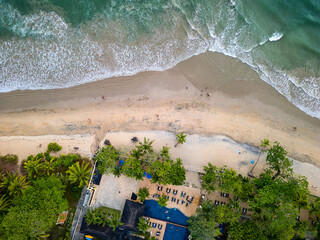 Top down aerial view of a deserted tropical beach fringed by palm trees (Khao Lak, Thailand)