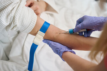 Close up view on injecting medication with syringe