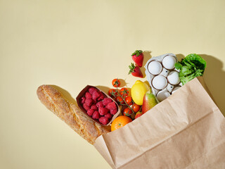 Full paper grocery bag with healthy products. Organic food concept, copy space