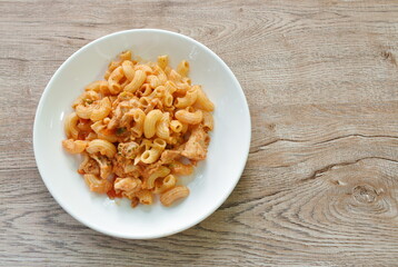stir fried rigatoni pasta with chicken dressing ketchup on plate