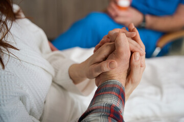 Couple giving helping hand to each other indoors