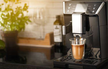 Professional coffee machine for home use with a mug of coffee with milk on a beautiful home kitchen background with a plant and sunbeams in the background. Coffee or coffee machine advertisement
