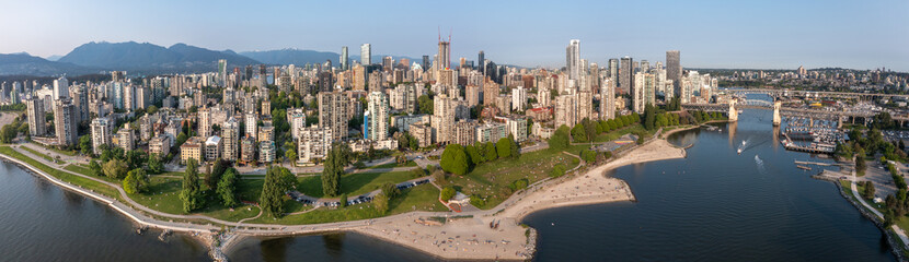 Vancouver, BC, Canada, panoramic aerial city view of Downtown Vancouver in British Columbia, Canada with skyscrapers and buildings in front and mountains in background 