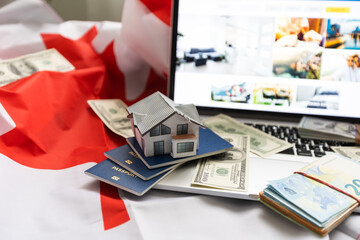 laptop with travel, money and canada flag