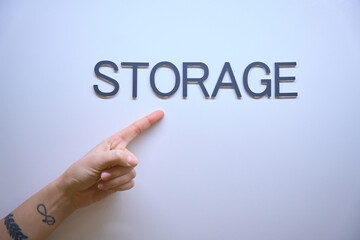 Close-up of storage signature, female hand pointing