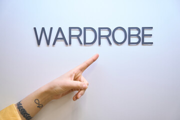 Close up of woman hand showing at wardrobe sign